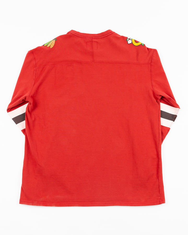 red Alice & Wonder long sleeve tee with diagonal Chicago wordmark and Chicago Blackhawks secondary and primary logo on shoulders and jersey-inspired stripes on sleeves - back lay flat