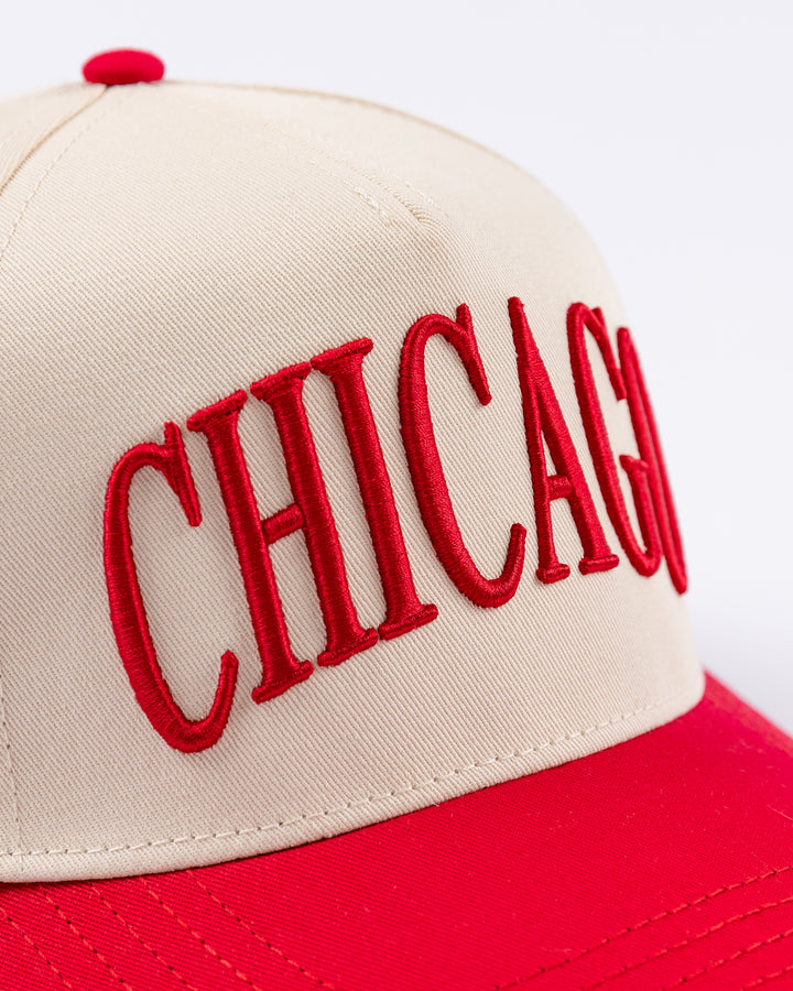 cream and red Alice & Wonder hat with Chicago wordmark on front and Chicago Blackhawks primary logo on left side - front detail lay flat