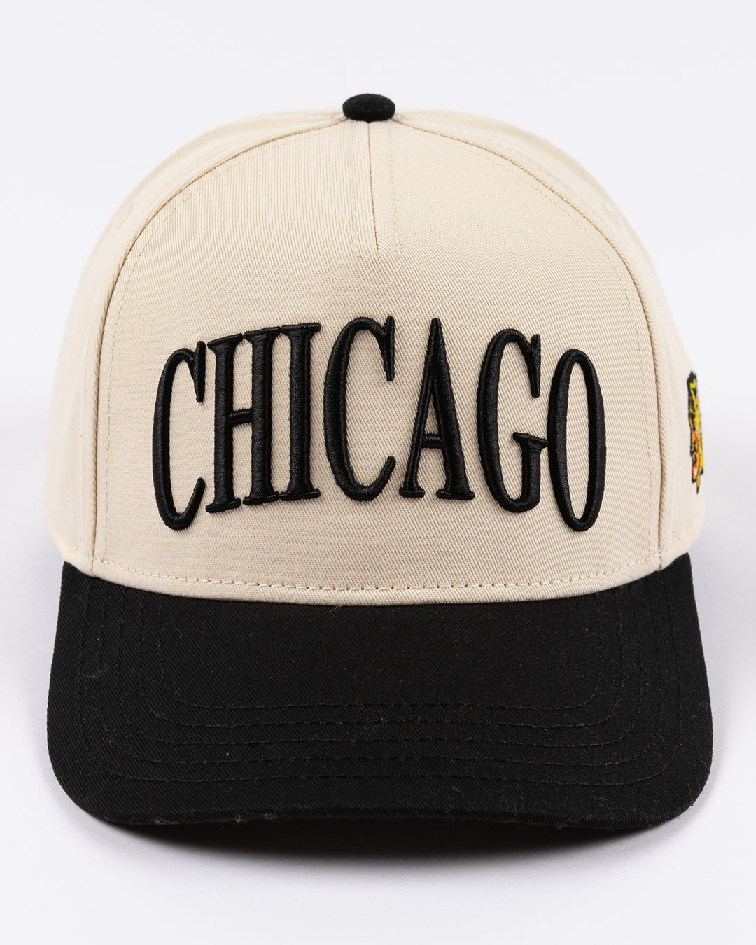 cream and black Alice & Wonder hat with Chicago wordmark on front and Chicago Blackhawks primary logo on left side - front lay flat