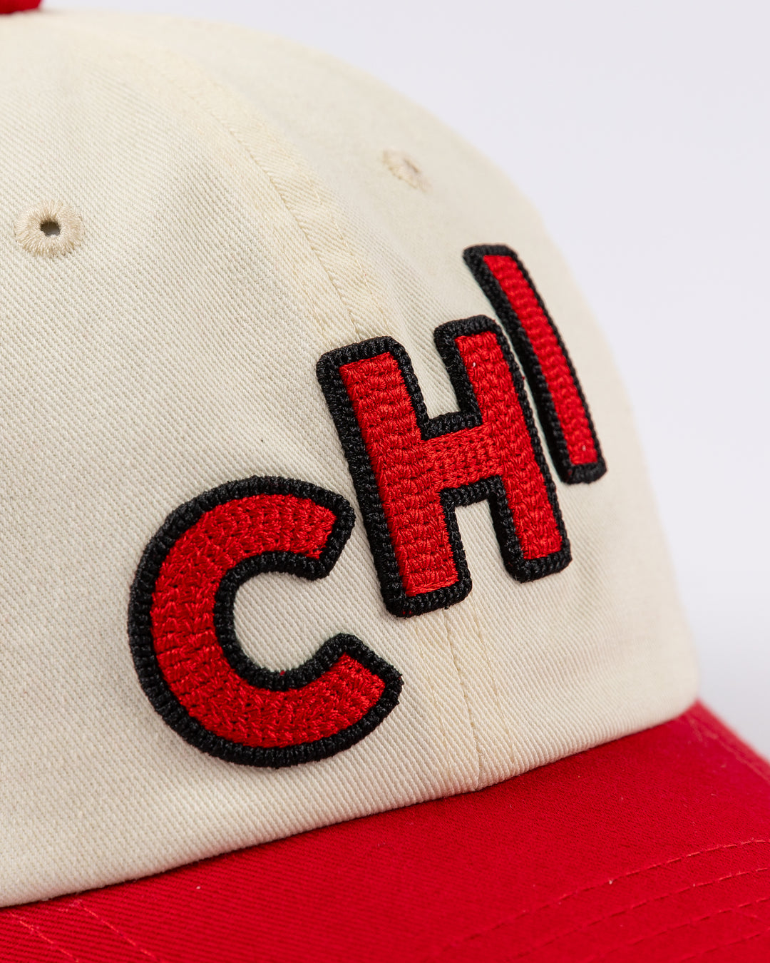 two tone red and white Alice & Wonder baseball hat with embroidered CHI detailing on front and Blackhawks wordmark on back - detail lay flat