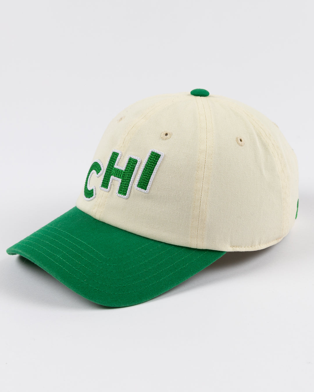 cream and green Alice & Wonder hat with CHI chain stitched on front with Blackhawks wordmark on back - left angle lay flat