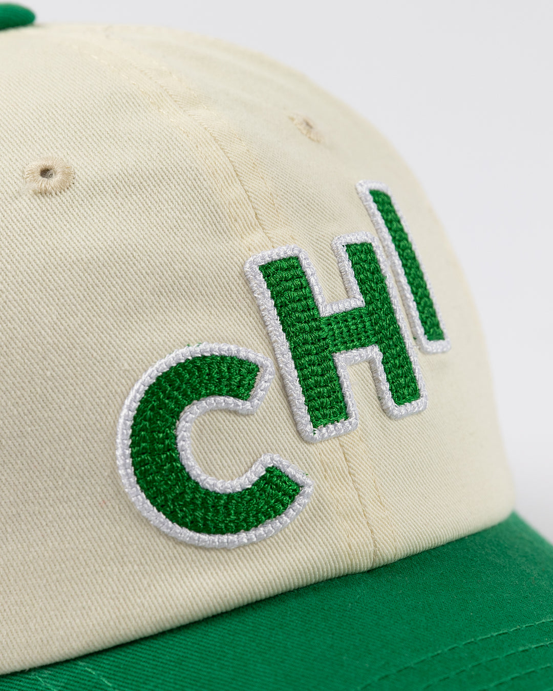 cream and green Alice & Wonder hat with CHI chain stitched on front with Blackhawks wordmark on back - front detail lay flat