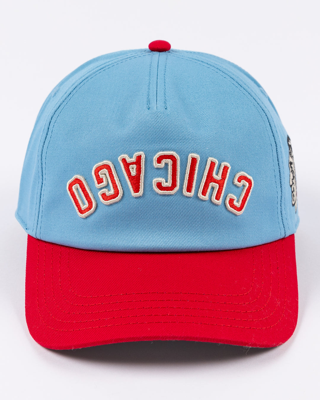 blue and red American Needle hat with upside down Chicago wordmark embroidered on front and Chicago Blackhawks primary logo on left side - front lay flat