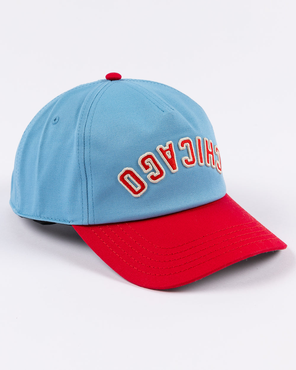 blue and red American Needle hat with upside down Chicago wordmark embroidered on front and Chicago Blackhawks primary logo on left side - right angle lay flat