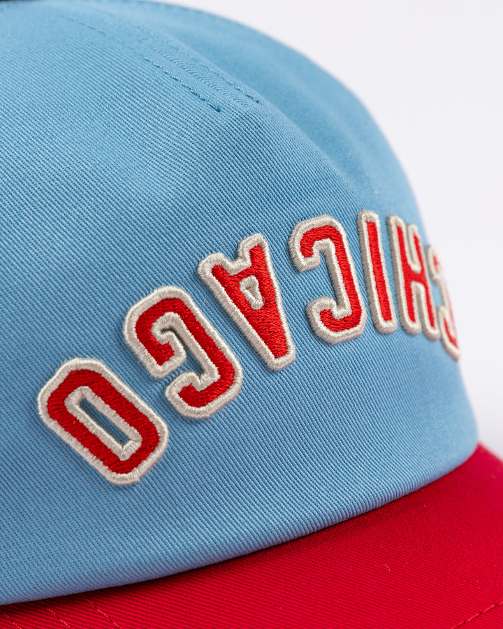 blue and red American Needle hat with upside down Chicago wordmark embroidered on front and Chicago Blackhawks primary logo on left side - front detail lay flat