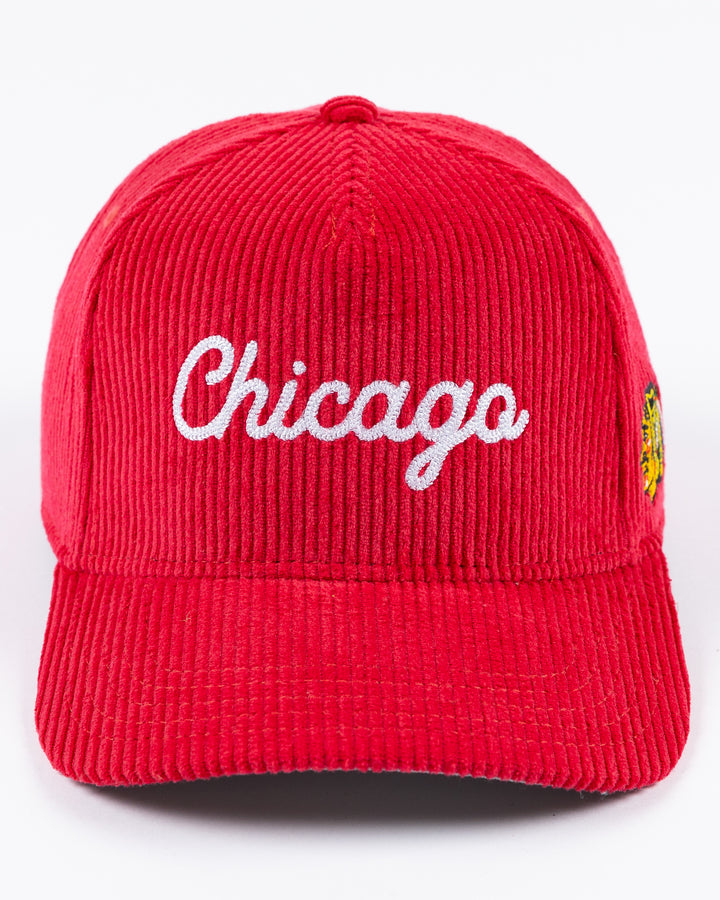 red corduroy Alice & Wonder adjustable hat with white chainstitched Chicago script graphic on front and Chicago Blackhawks primary logo on left side - front lay flat