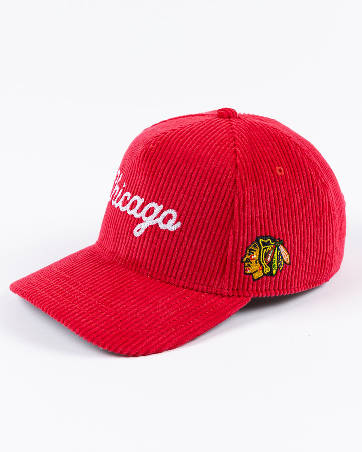 red corduroy Alice & Wonder adjustable hat with white chainstitched Chicago script graphic on front and Chicago Blackhawks primary logo on left side - left angle lay flat