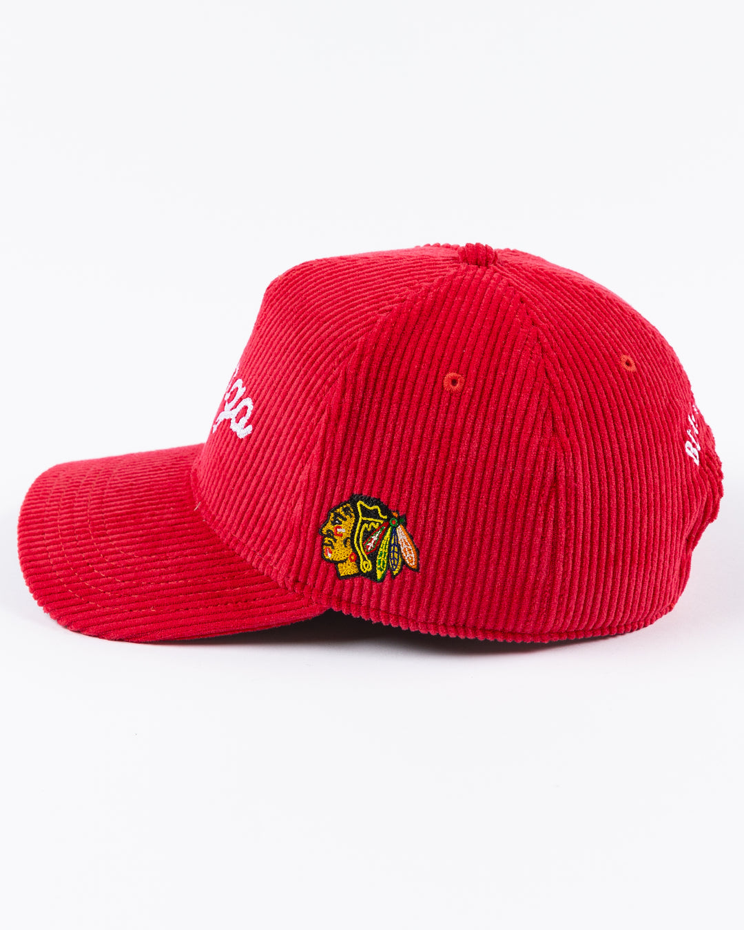 red corduroy Alice & Wonder adjustable hat with white chainstitched Chicago script graphic on front and Chicago Blackhawks primary logo on left side - left side lay flat