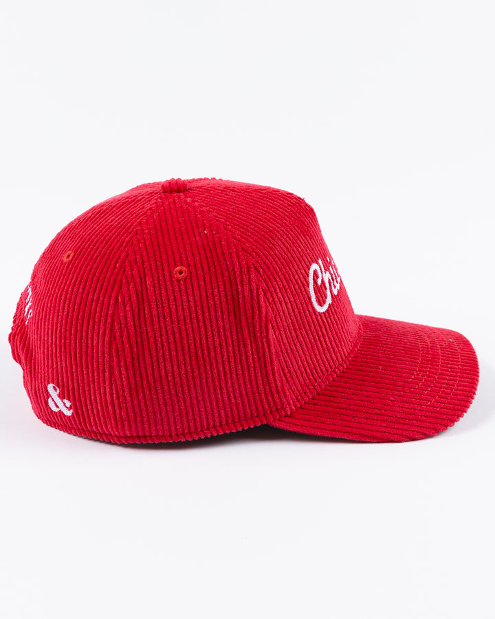 red corduroy Alice & Wonder adjustable hat with white chainstitched Chicago script graphic on front and Chicago Blackhawks primary logo on left side - left side lay flat