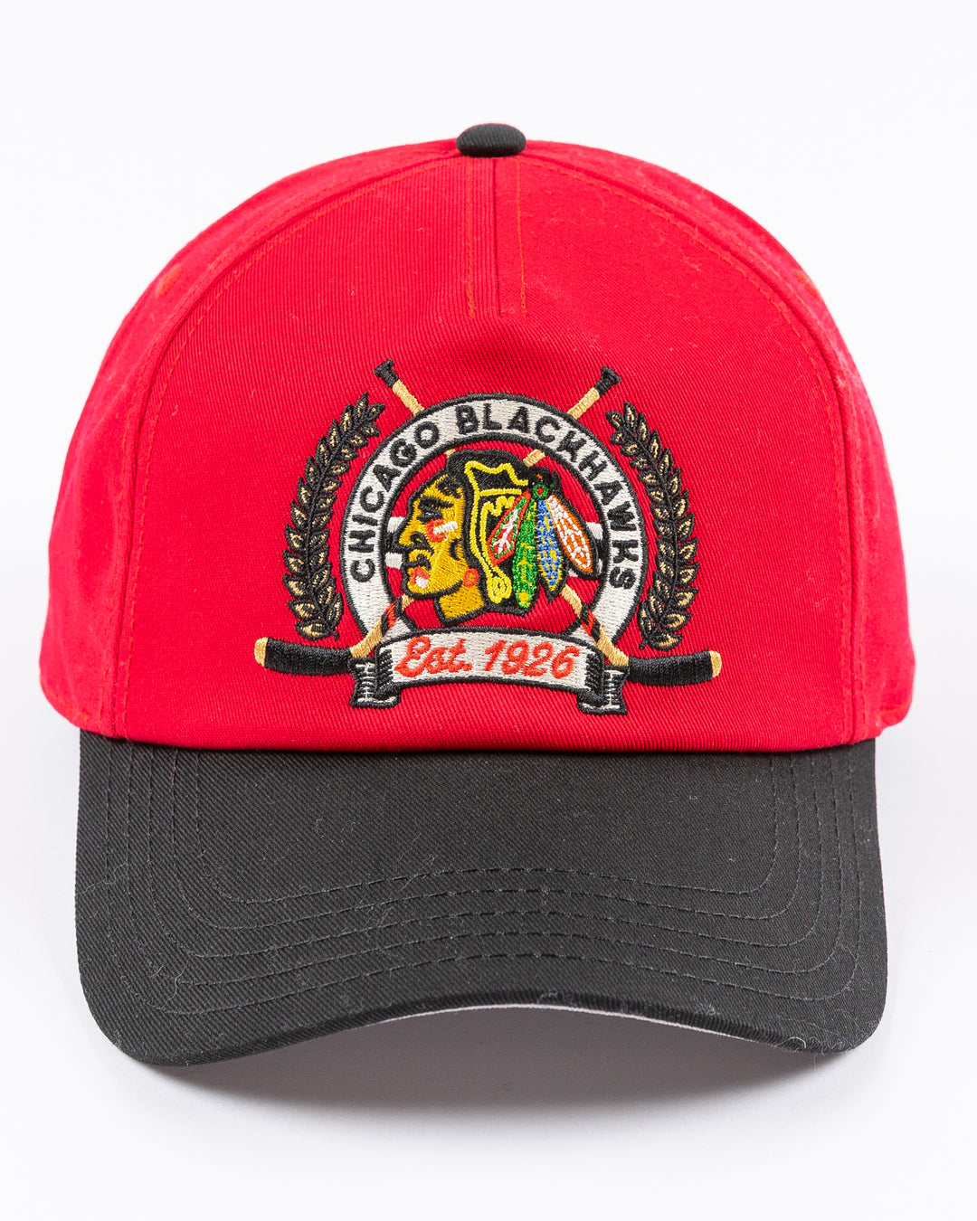 American Needle adjustable two tone red and black hat with Chicago Blackhawks primary logo and two crossed hockey sticks embroidered on front - front lay flat