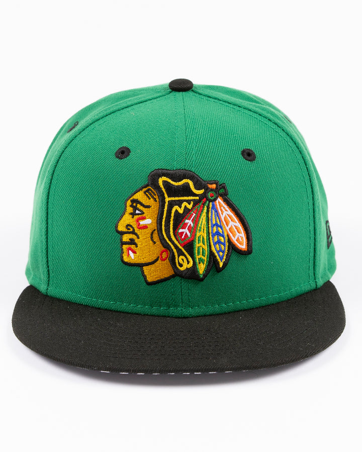 green and black New Era 9FIFTY snapback with Chicago Blackhawks primary logo embroidered on front and black and white star pattern on bottom brim - front lay flat