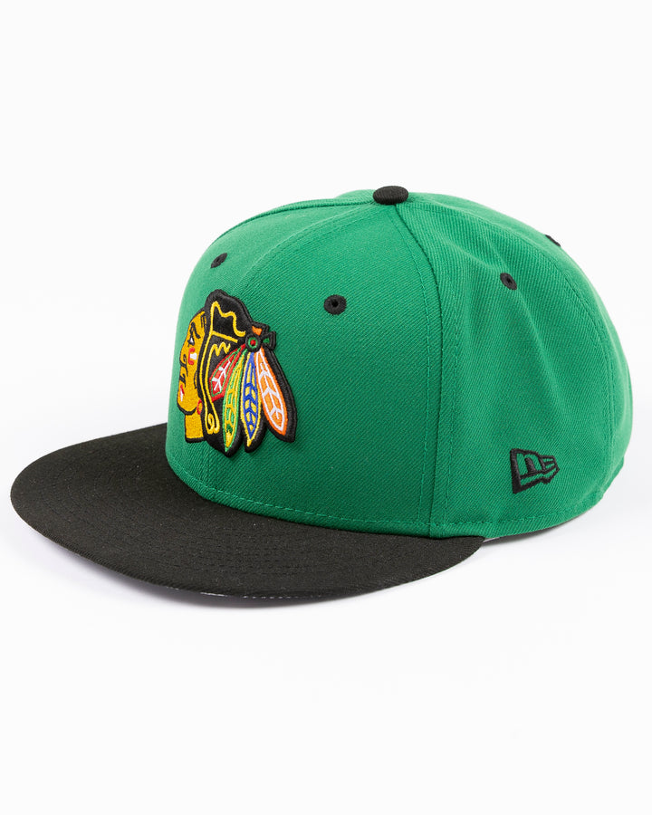 green and black New Era 9FIFTY snapback with Chicago Blackhawks primary logo embroidered on front and black and white star pattern on bottom brim - left angle lay flat