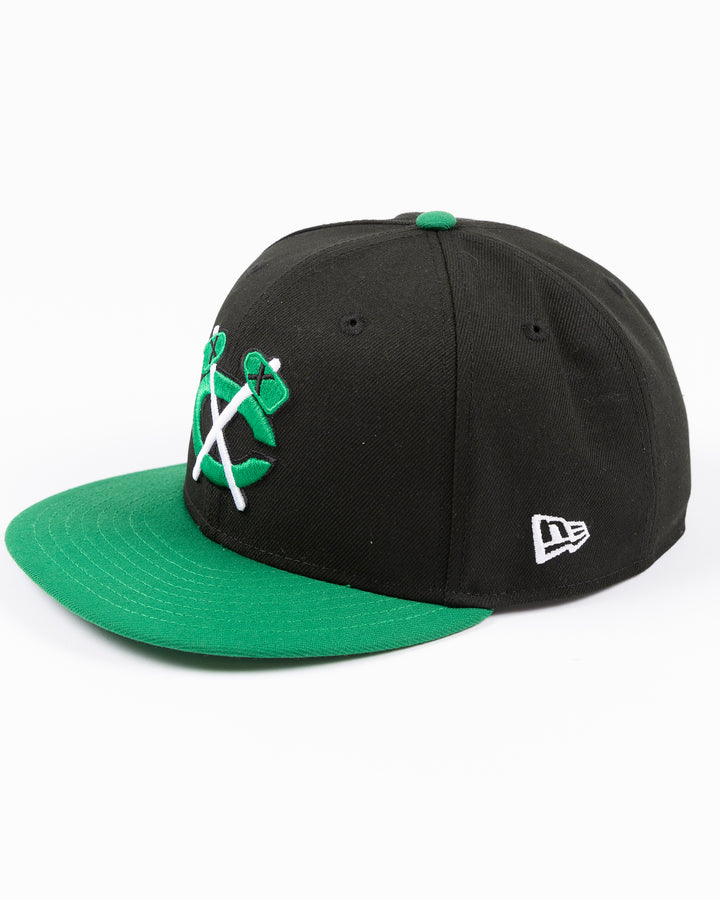 black and green two tone New Era 9FIFTY snapback with tonal Chicago Blackhawks secondary logo embroidered on front - left angle lay flat