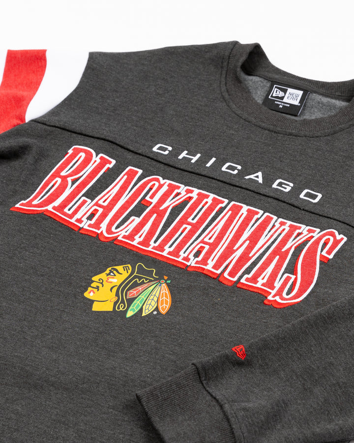 black New Era ladies crewneck with Chicago Blackhawks wordmark graphic above primary logo across front - front detail lay flat