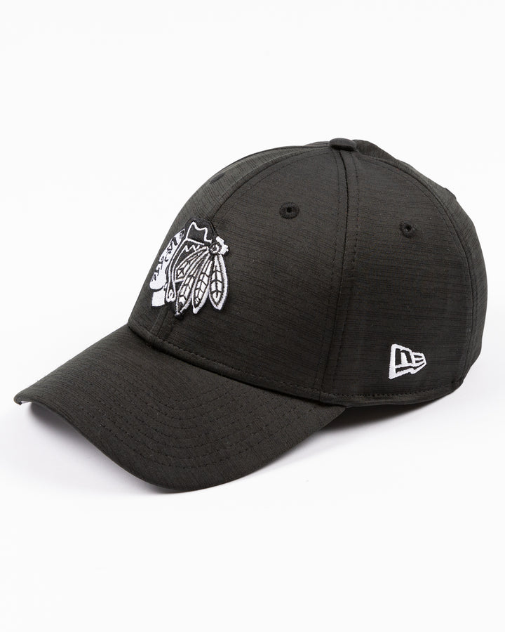 black New Era fitted hat with tonal embroidered Chicago Blackhawks primary logo on front - left angle lay flat