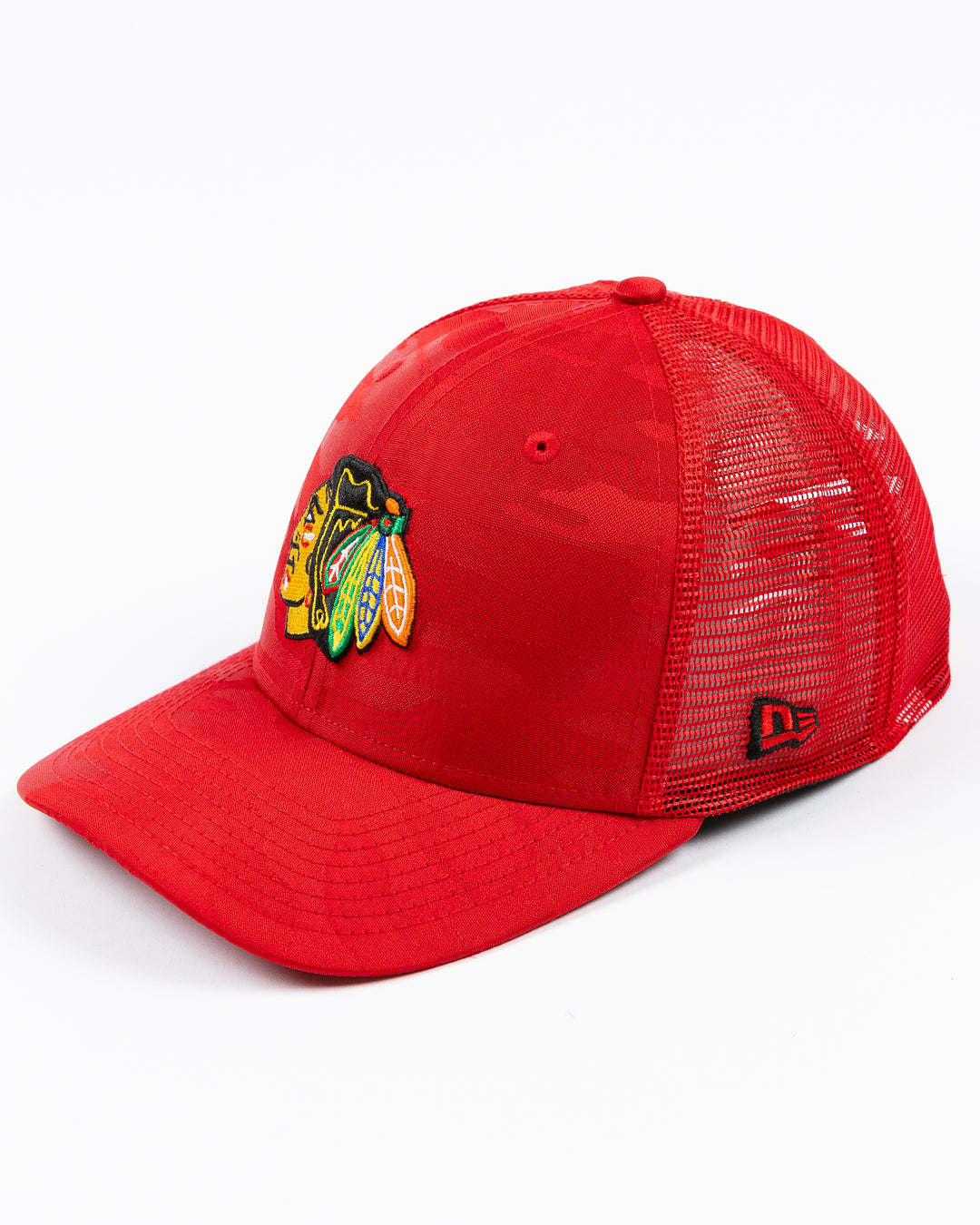 red camo New Era trucker cap with embroidered Chicago Blackhawks primary logo on front - left angle lay flat