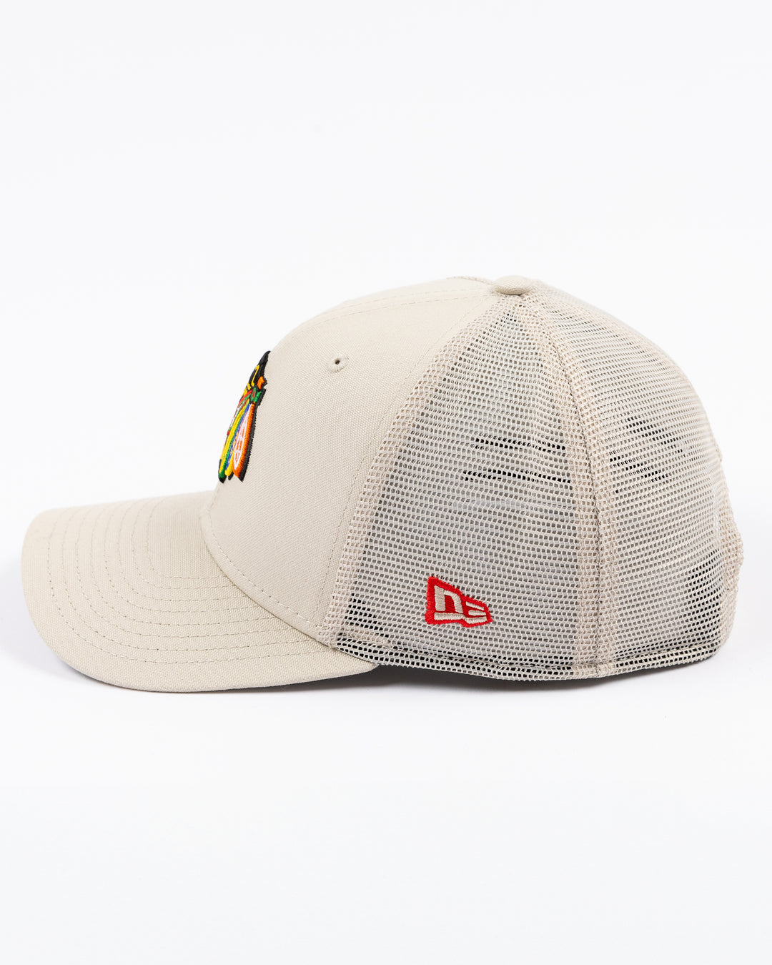 beige New Era adjustable snapback cap with Chicago Blackhawks primary logo embroidered on front - left side lay flat