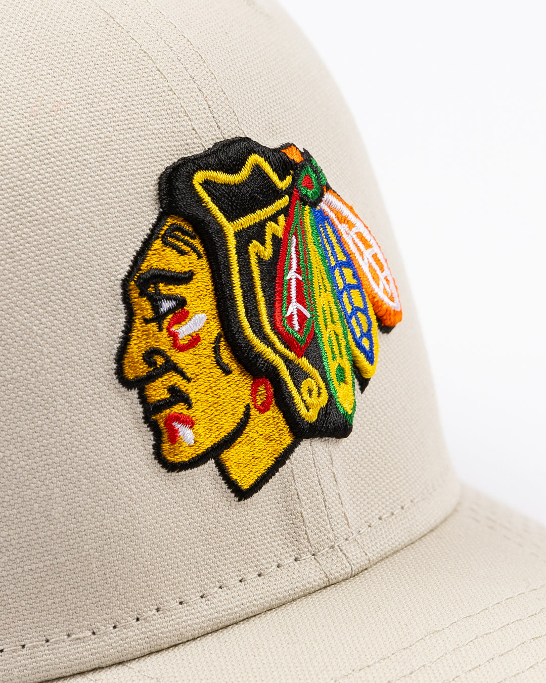 beige New Era adjustable snapback cap with Chicago Blackhawks primary logo embroidered on front - front detail lay flat