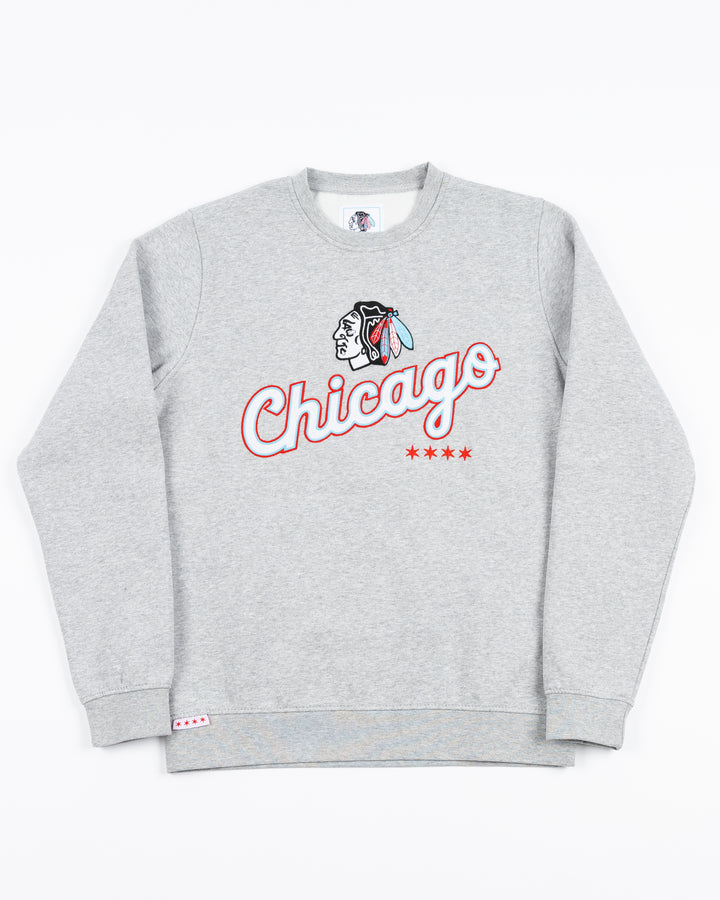 grey crewneck with Chicago script word graphic across front below Chicago Blackhawks primary logo in Chicago flag-inspired colorway - front lay flat