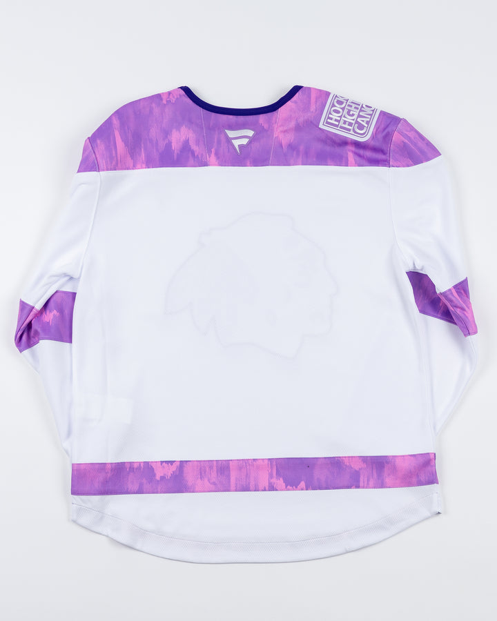 white Fanatics jersey with purple tie dye accents for Hockey Fights Cancer and Chicago Blackhawks tonal primary logo on the front and customizable tag on left hem - back lay flat