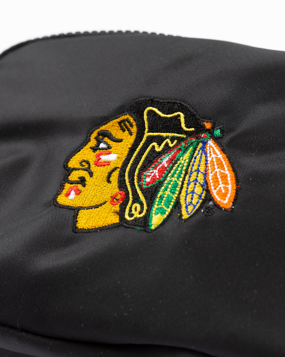 black lululemon belt bag with embroidered Chicago Blackhawks primary logo on front - front detail lay flat