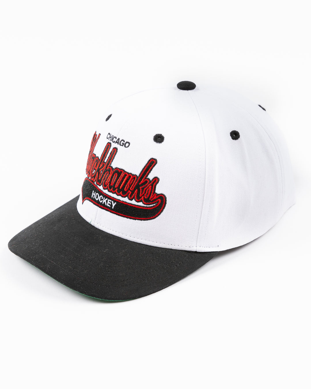 black and white Mitchell & Ness adjustable cap with embroidered Chicago Blackhawks hockey wordmark on front and primary logo on right side - left angle lay flat