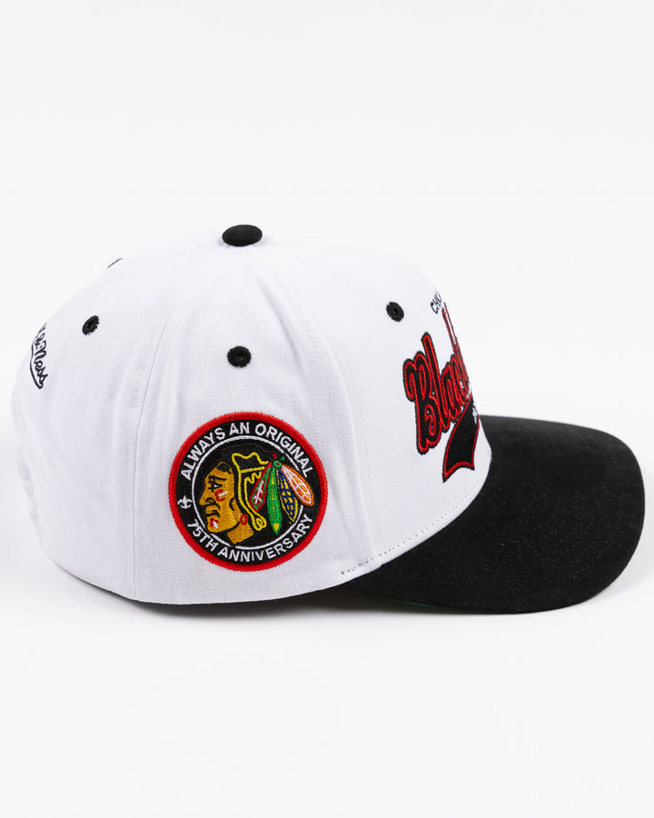 black and white Mitchell & Ness adjustable cap with embroidered Chicago Blackhawks hockey wordmark on front and primary logo on right side - right side lay flat