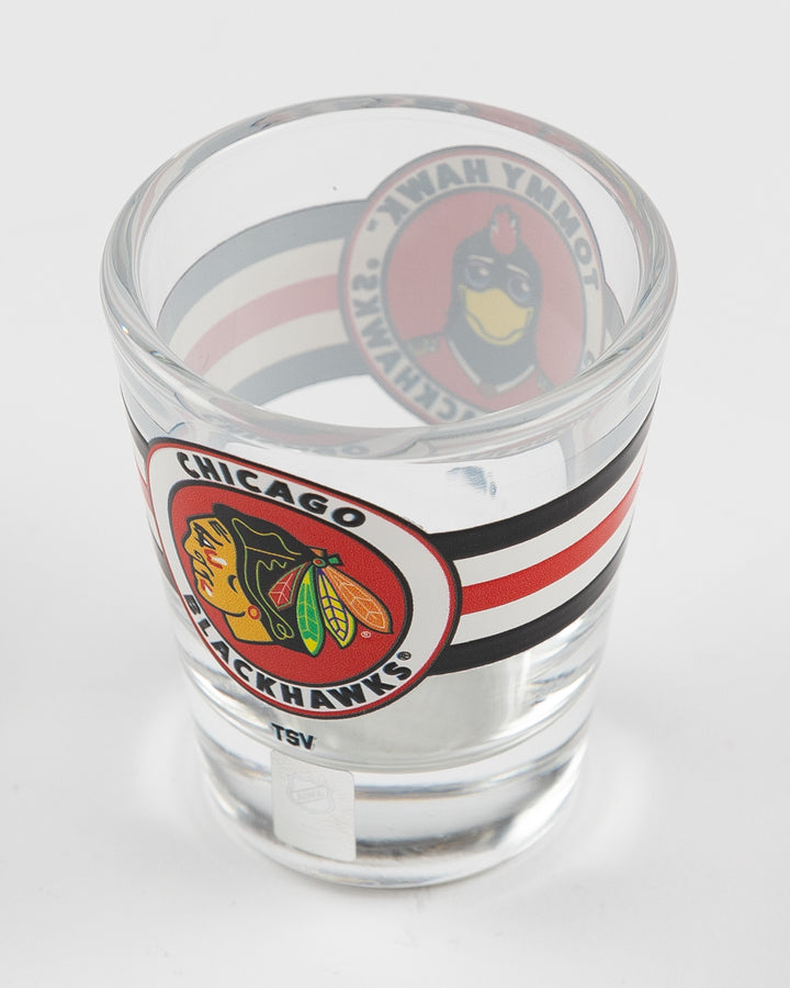 shot glass with Chicago Blackhawks mascot Tommy on classic stripe design - above angle lay flat