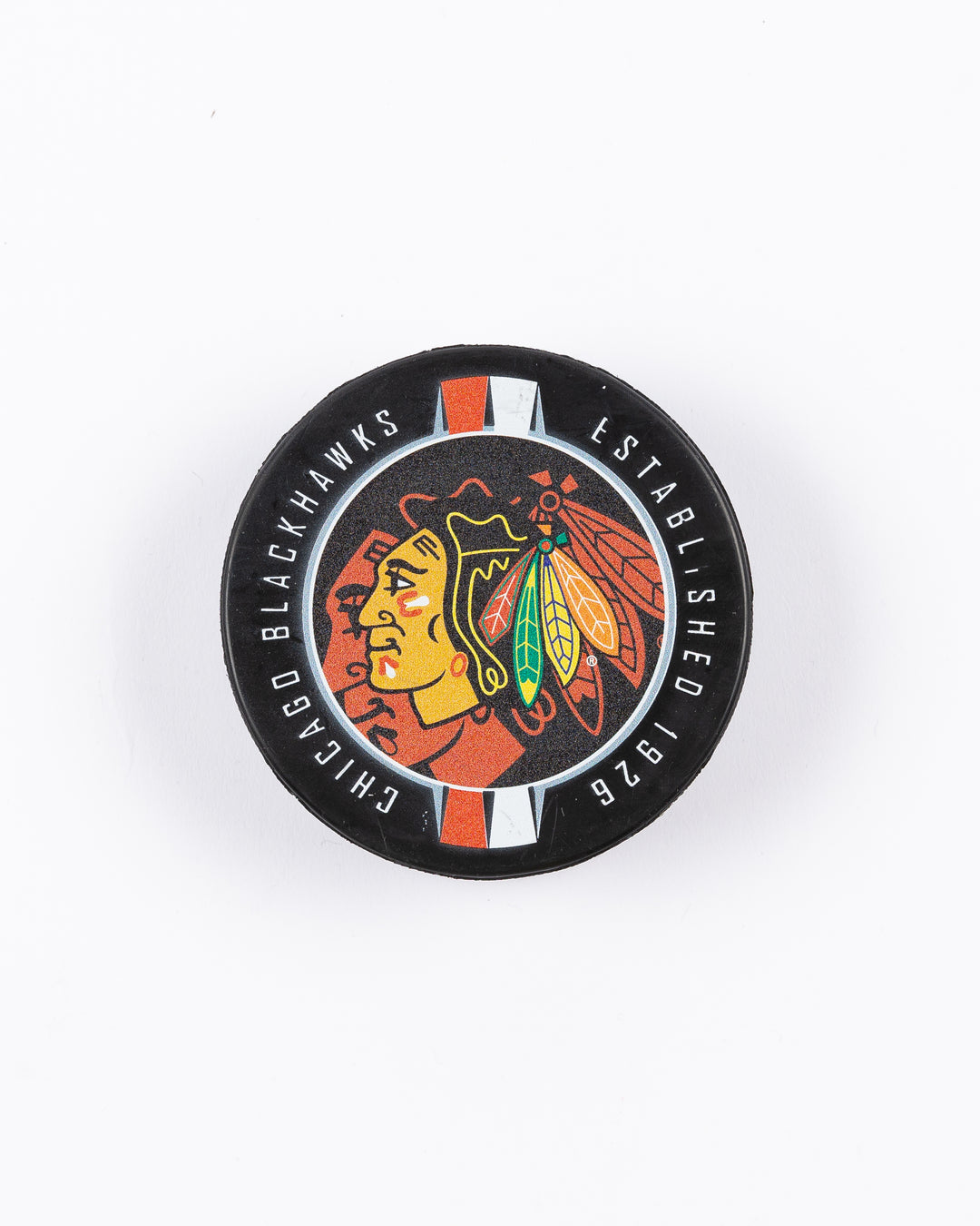 hockey puck with Chicago Blackhawks primary logo and ribbon-inspired design - front lay flat