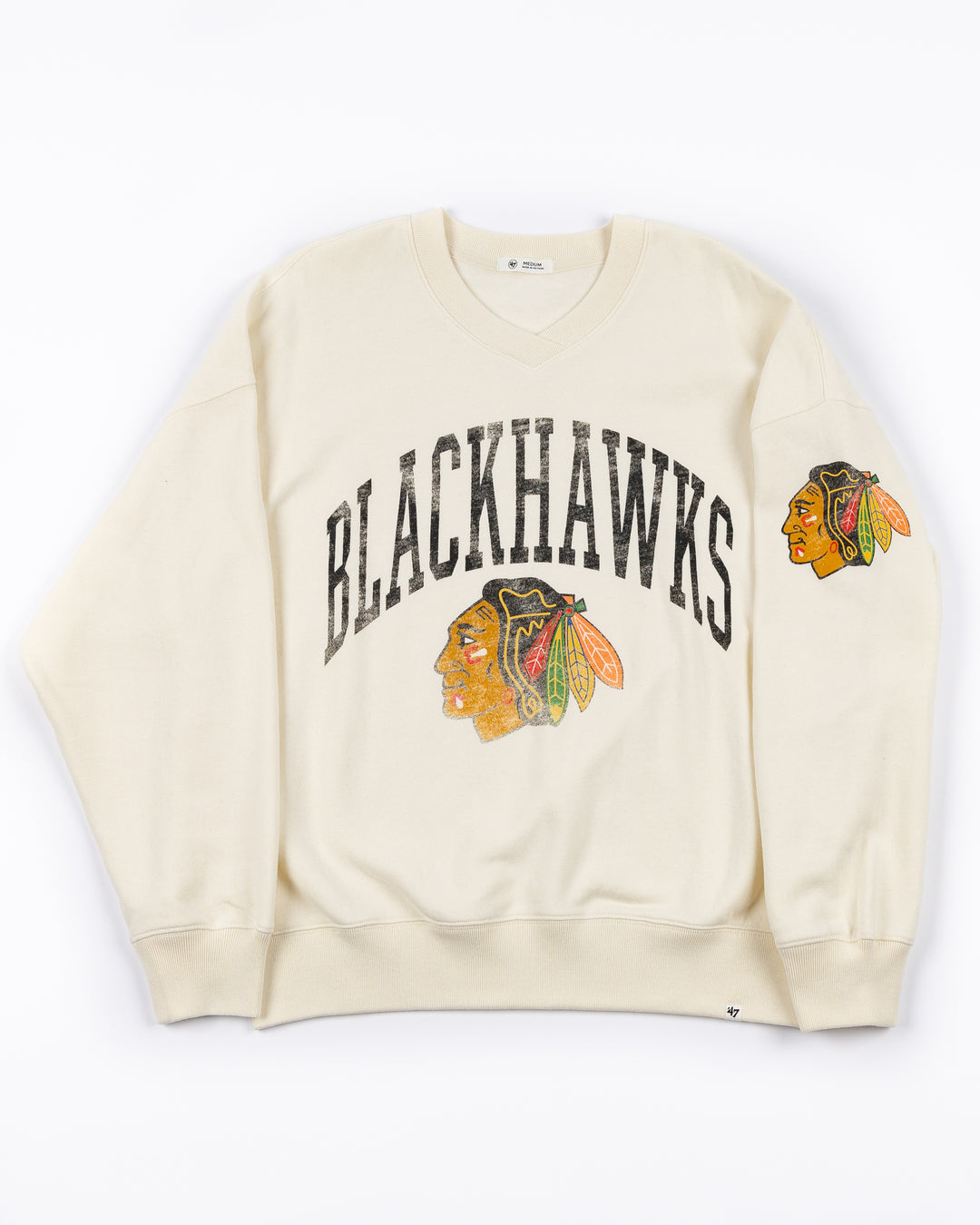 beige ladies women's pullover with Chicago Blackhawks wordmark and primary logo on front and primary logo on left arm - front lay flat