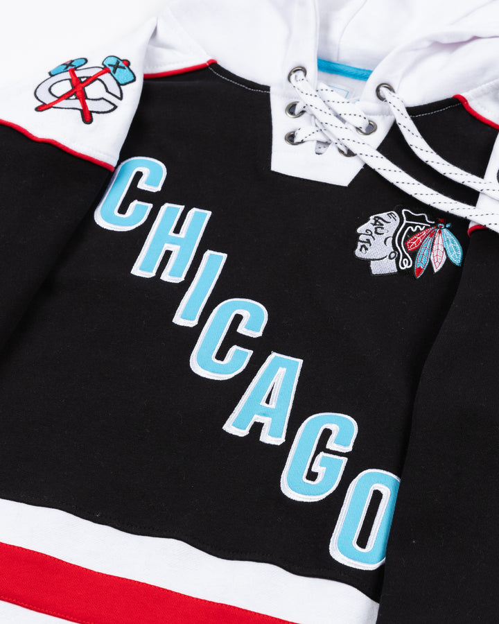 black and white lacer hoodie with diagonal Chicago wordmark on front with Chicago Blackhawks primary logo on left chest and secondary logos adorning shoulders - front detail lay flat