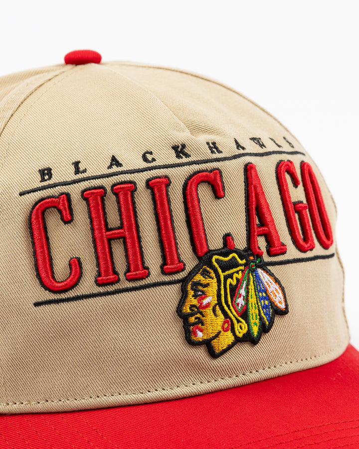 khaki '47 brand adjustable cap with Chicago Blackhawks wordmark and primary logo embroidered on front with red visor - front detail lay flat