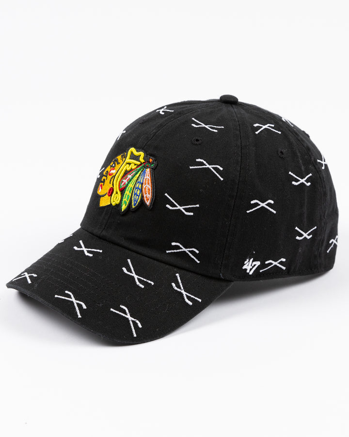 black '47 brand clean up adjustable cap with Chicago Blackhawks primary logo embroidered on front with all over hockey stick pattern - left angle lay flat