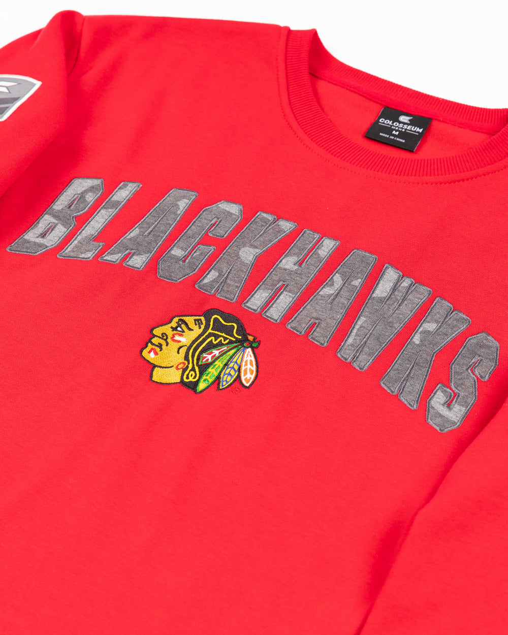 red Colosseum OHT crewneck sweater with Chicago Blackhawks wordmark in camo and primary logo on front and patches on sleeves - front detail lay flat