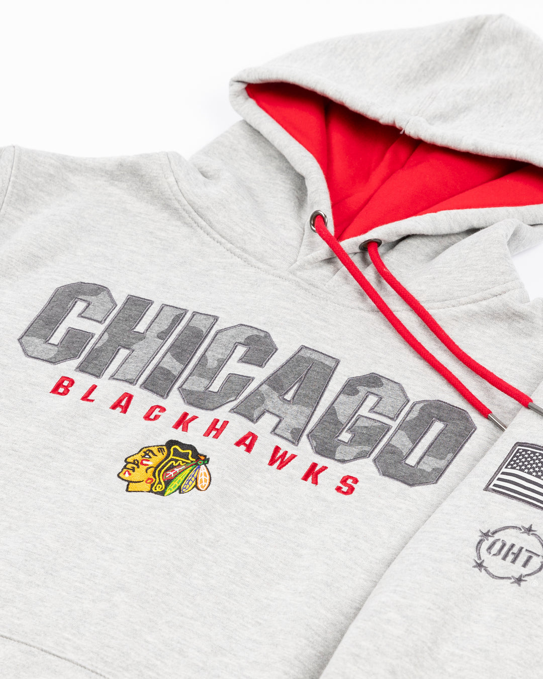 grey Colosseum OHT hoodie with Chicago Blackhawks wordmark in camo and primary logo on front and patches on sleeves - front detail lay flat