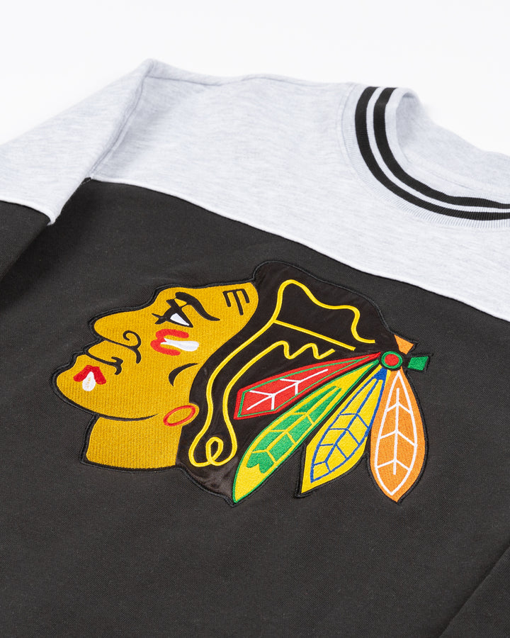 color blocked black and grey '47 brand crewneck with Chicago Blackhawks primary logo across front - front angle lay flat