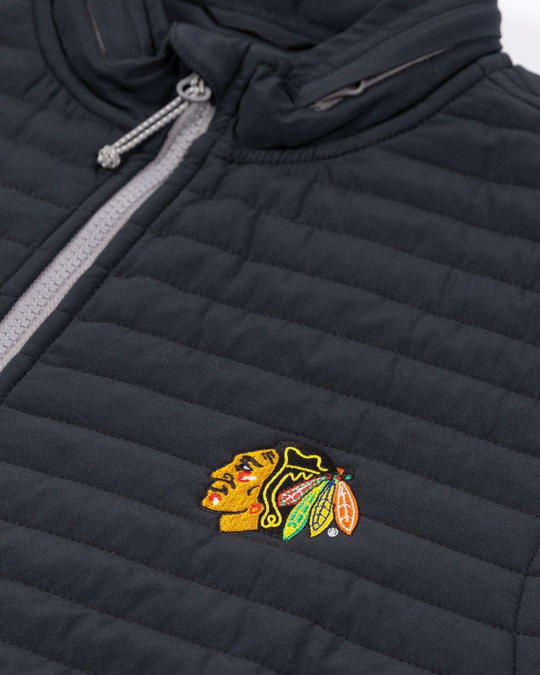 black johnnie-o full zip vest with Chicago Blackhawks primary logo on left chest - front detail lay flat