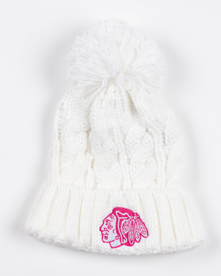 white Outerstuff youth knit hat with white pom and pink tonal Chicago Blackhawks primary logo embroidered on front - front lay flat