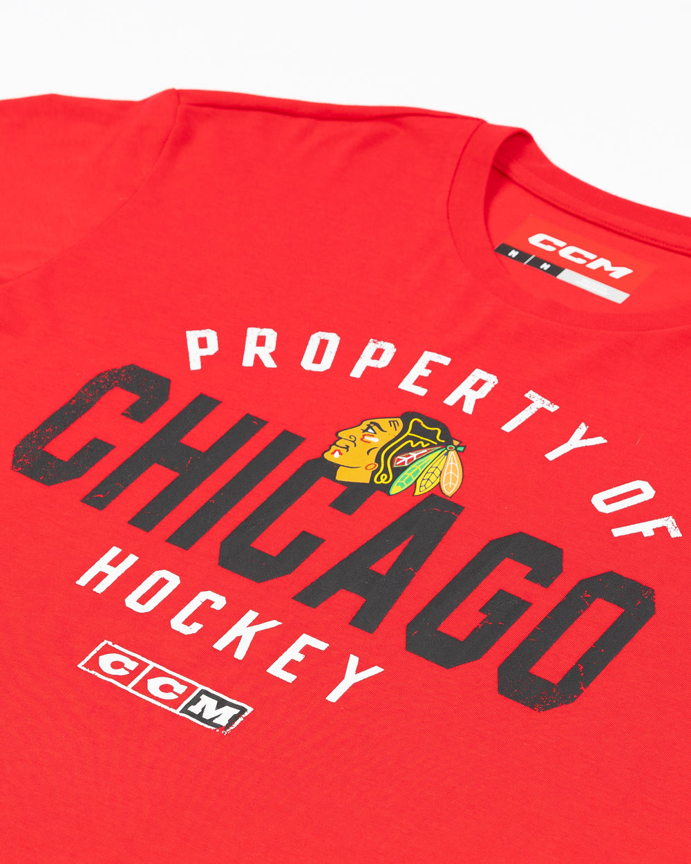 red CCM short sleeve tee with property of Chicago hockey wordmark and Chicago Blackhawks primary logo on front - front detail lay flat