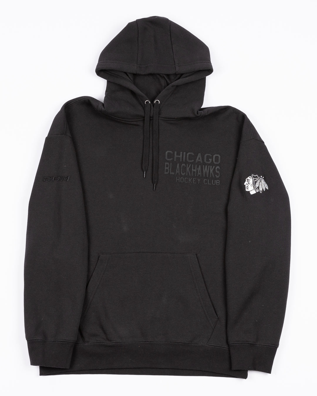 black CCM hoodie with tonal Chicago Blackhawks Hockey Club wordmark graphic on left chest and black and white primary logo embroidered on left shoulder - front lay flat