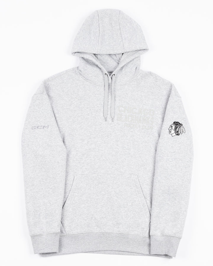 grey CCM hoodie with tonal Chicago Blackhawks Hockey wordmark on left chest and black and white Chicago Blackhawks primary logo on left shoulder - front lay flat