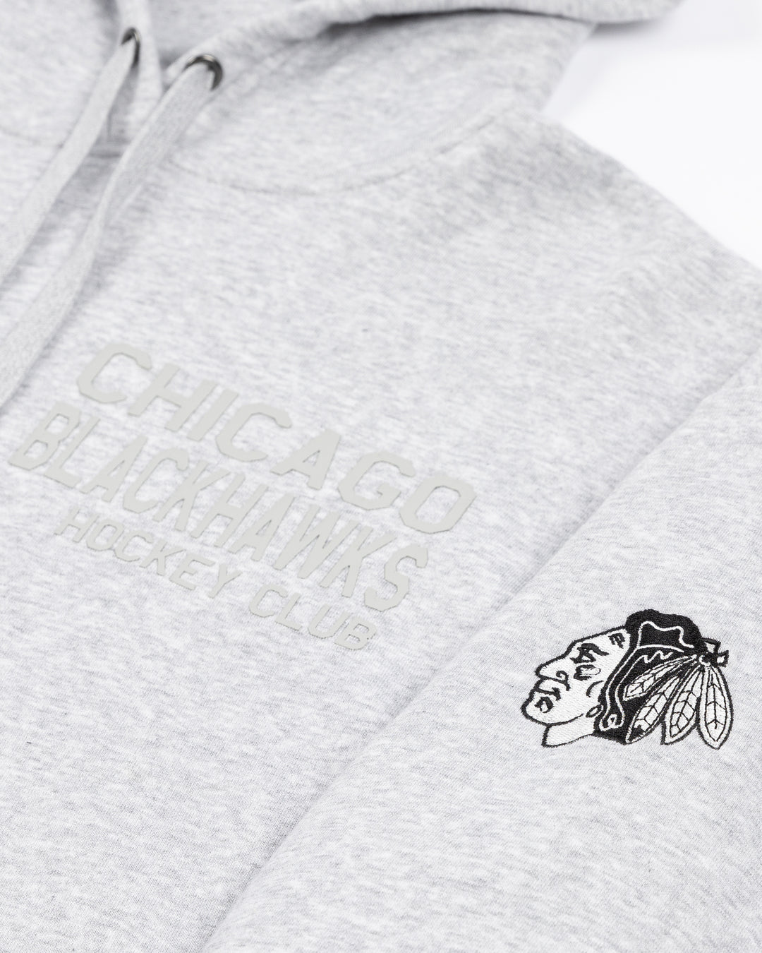 grey CCM hoodie with tonal Chicago Blackhawks Hockey wordmark on left chest and black and white Chicago Blackhawks primary logo on left shoulder - front detail lay flat