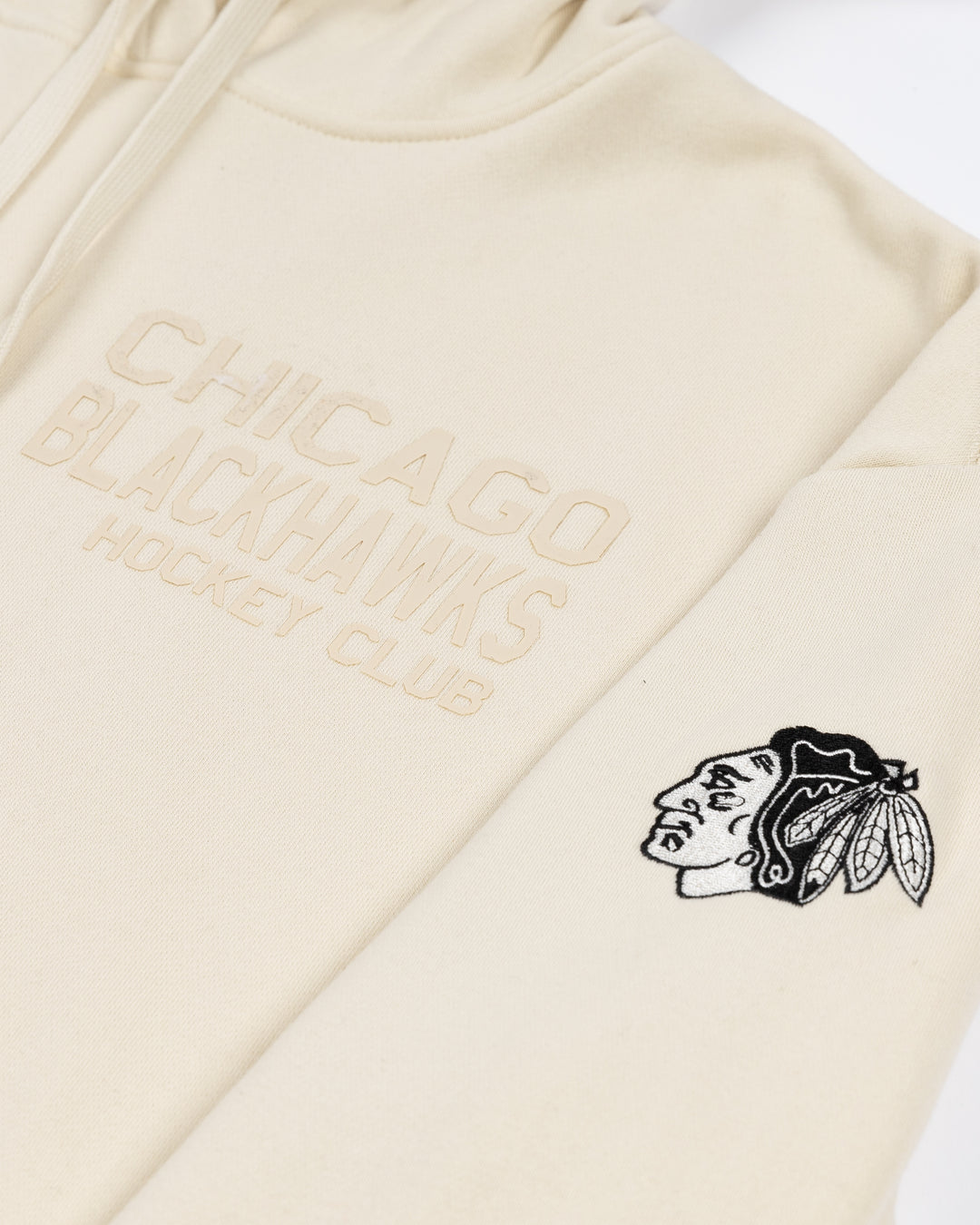 white CCM hoodie with tonal Chicago Blackhawks hockey wordmark graphic on left chest and black and white primary logo on left shoulder - front detail lay flat