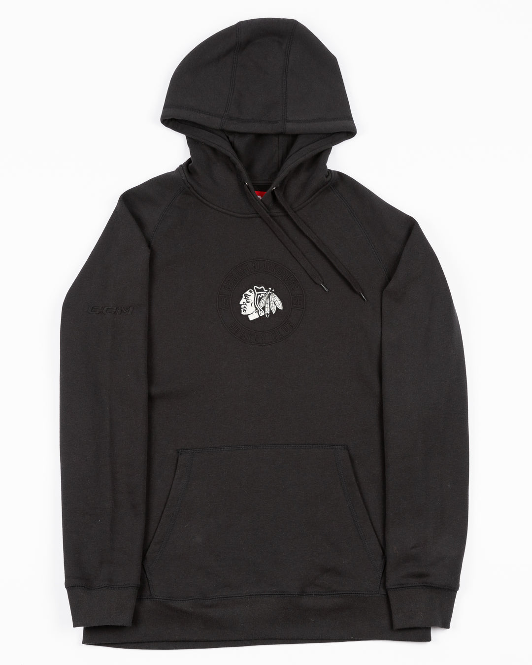 black CCM hoodie with Chicago Blackhawks black and white primary logo on front surrounded by tonal wordmark logo - front lay flat