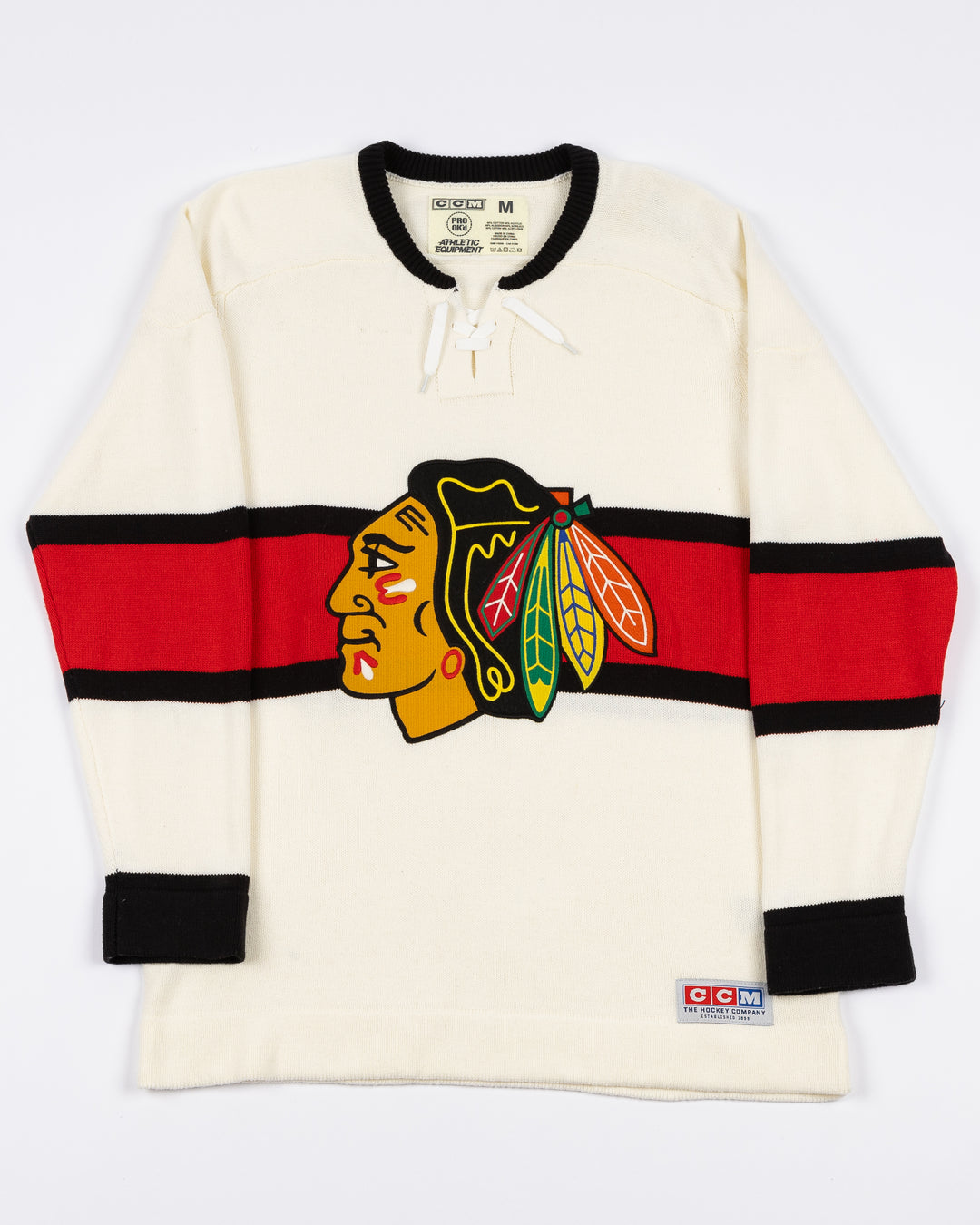 white CCM sweater with red and black stripe on center with Chicago Blackhawks primary logo across front with lace neck details - front lay flat