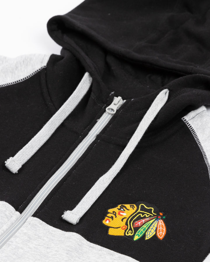 two-tone grey and blac CCM full zip hoodie with Chicago Blackhawks primary logo on left chest and CCM logo on right chest - front detail lay flat