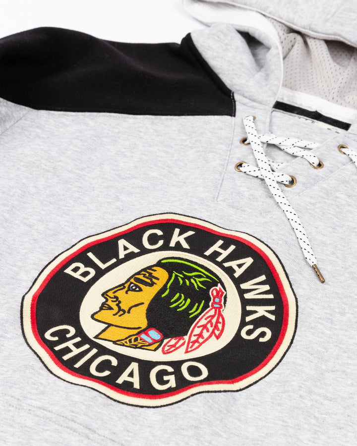 grey CCM jersey-inspired hoodie with vintage Chicago Blackhawks logo on front - front detail lay flat