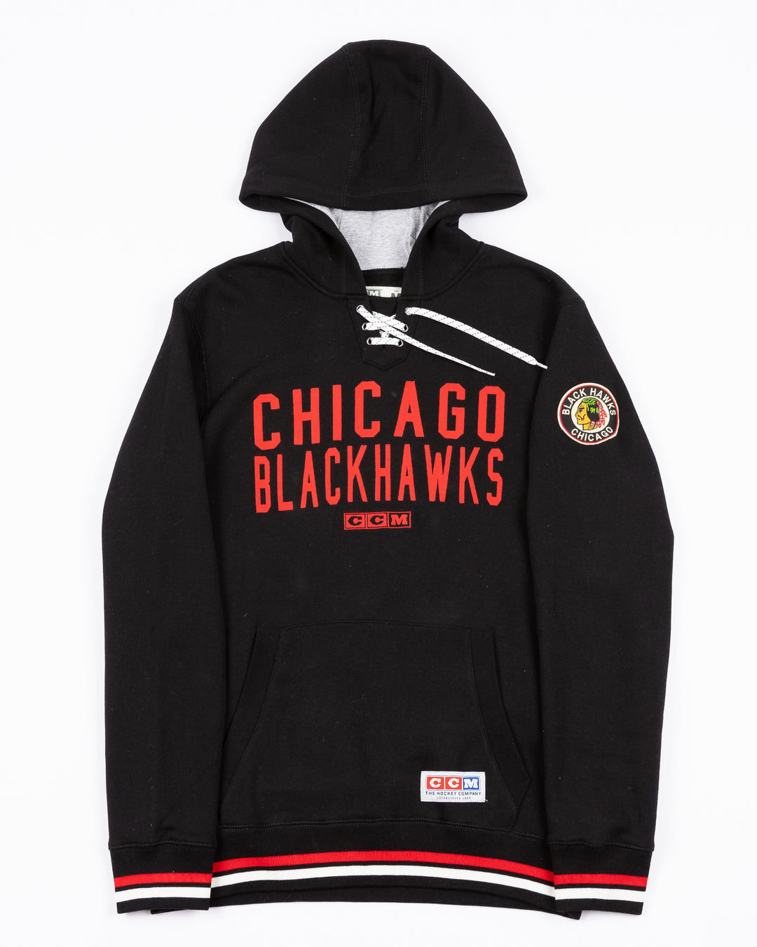 black CCM lacer hoodie with red Chicago Blackhawks wordmark across front and vintage Chicago Blackhawks logo on left shoulder - front lay flat