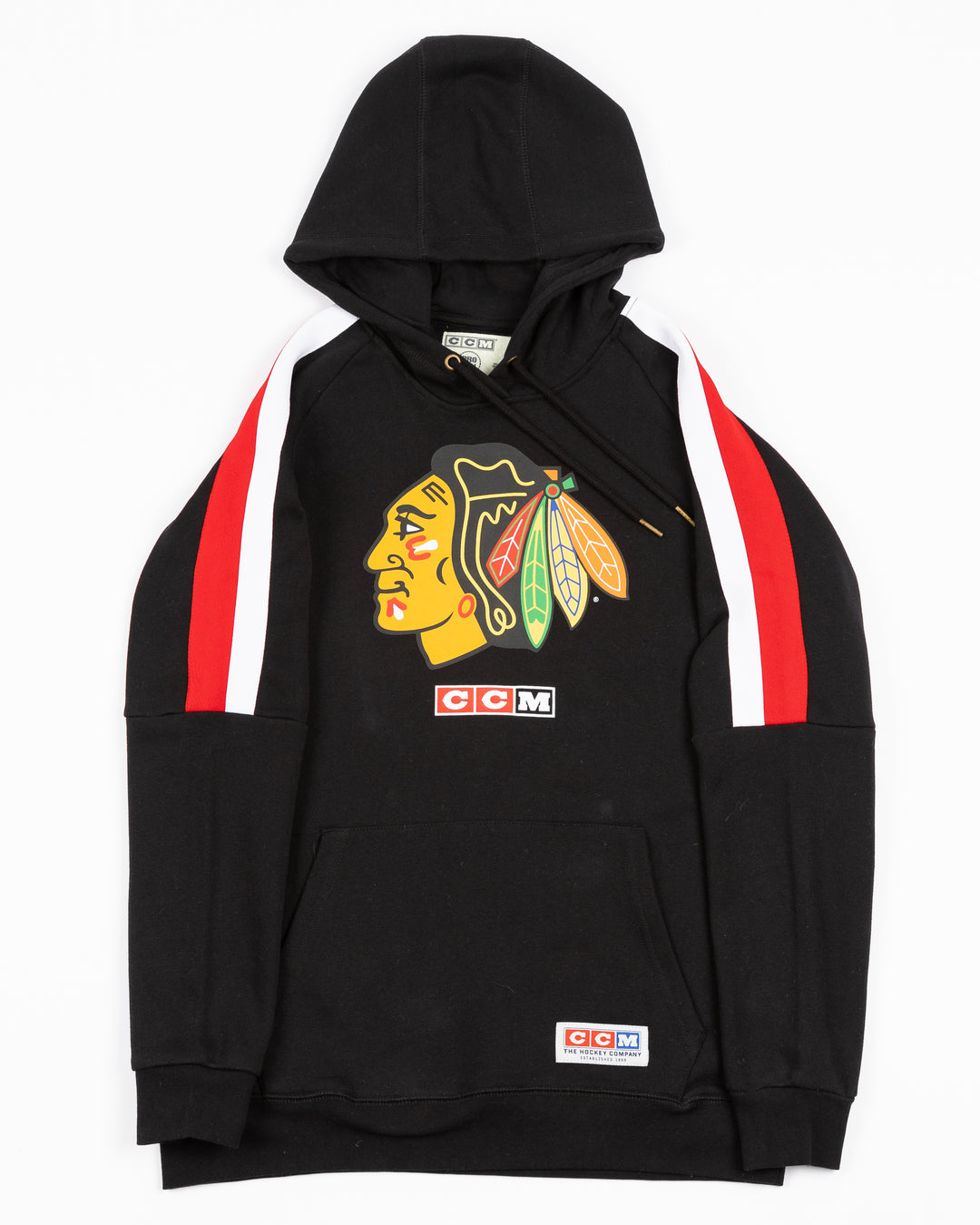 black CCM hoodie with red and white stripes on shoulders and Chicago Blackhawks primary logo on front - front lay flat