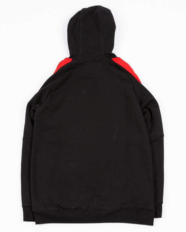 black CCM hoodie with red and white stripes on shoulders and Chicago Blackhawks primary logo on front - back lay flat